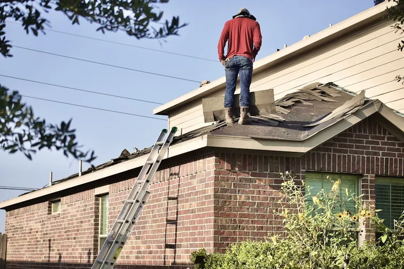 Professional roofer working on a residential roof in Prospect Heights